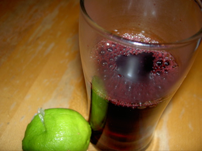 a glass of hot jamaica and a dismembered lime