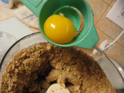 an egg yolk dropping into some toffee batter.