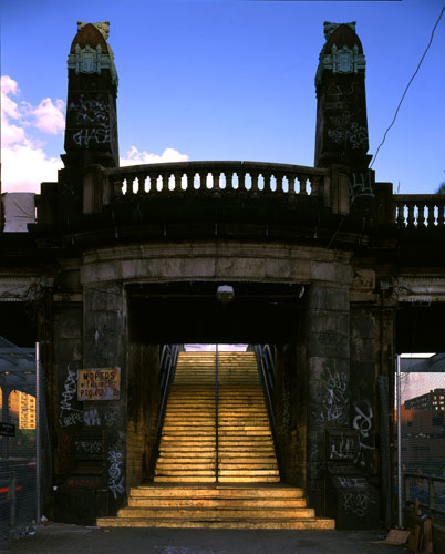 a gilded staircase in an old concrete bridge structure