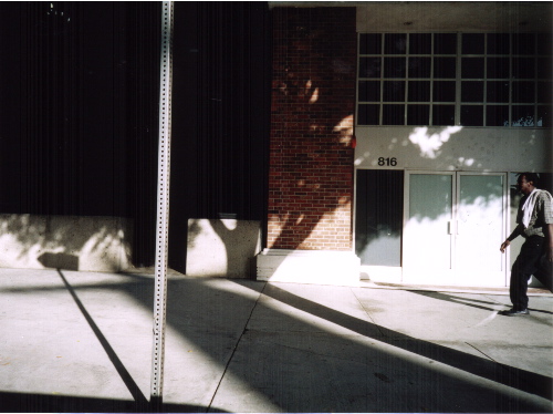 A man walking along the sidewalk.