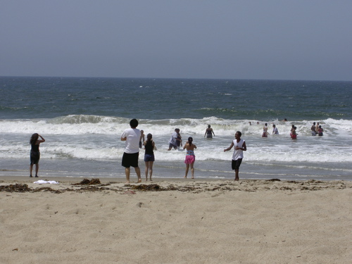 My friends, frolicking in the Pacific Ocean.