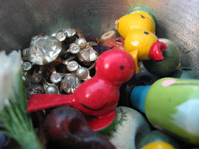 Some little toys in a pewter cup.