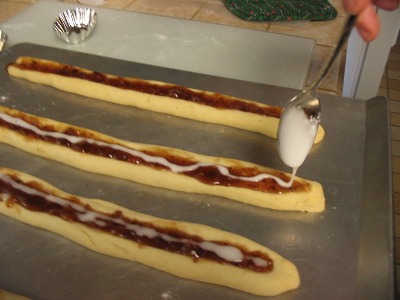 drizzling glaze (powdered sugar + milk) onto raspberry ribbons.