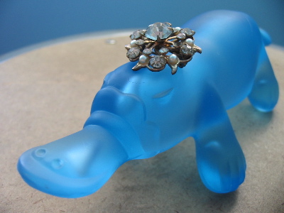 A jeweled, blue, translucent plastic platypus.