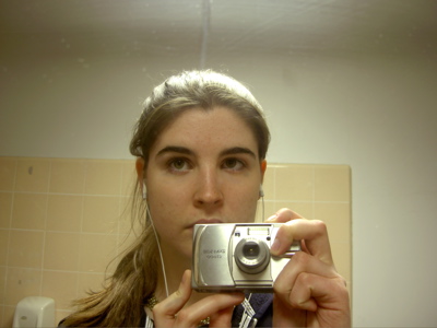 me in a bathroom mirror wearing ipod earbuds