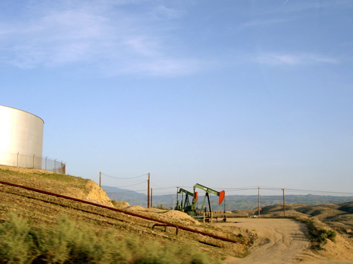 two red ones, with a tank and pipes in the foreground