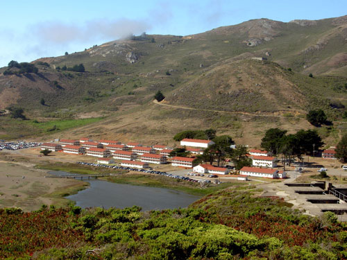 The red and white buildings in the distance.