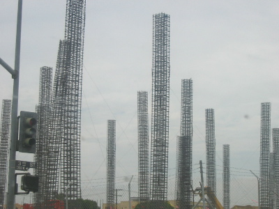 Reinforced-iron towers rise into the cloudy sky at a construction site in downtown LA.